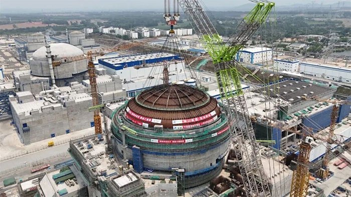 The 415-tonne outer dome being positioned above the reactor building cylinder
