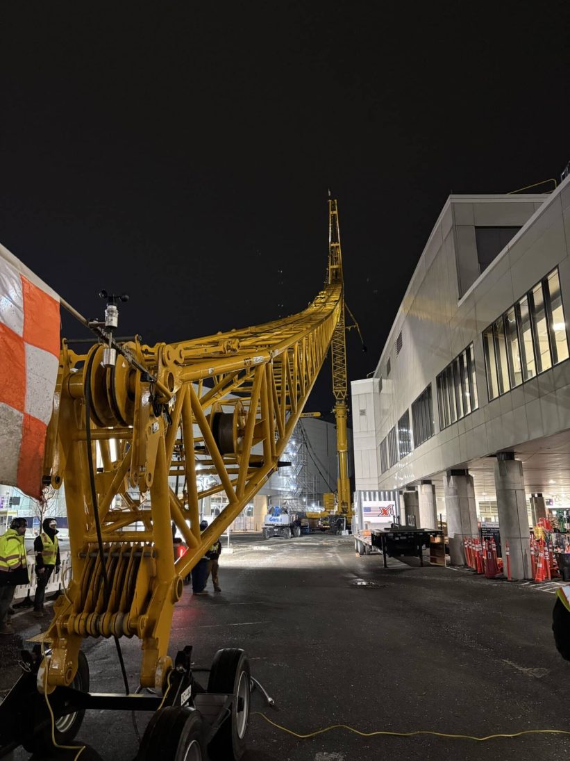 Luffing jib silhouetted against the night sky during the Boston Logan elevator bank project