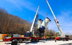 Link-Belt ATC-3275 all terrain crane and 120|HT truck crane lifting an ASTEC silo section in tandem in Kentucky