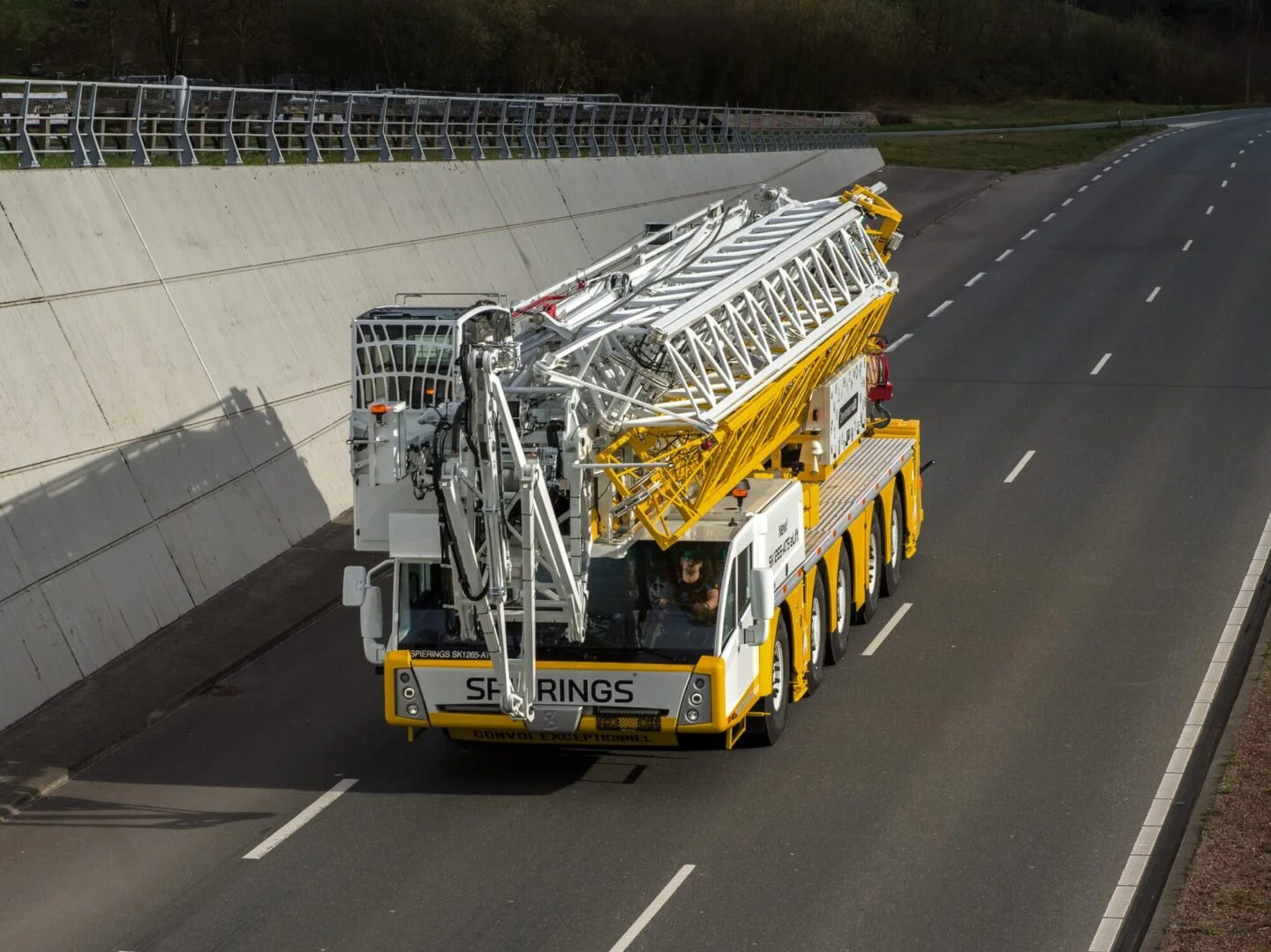 Spierings SK1265-AT5 eLift mobile tower crane travelling on a motorway in road configuration