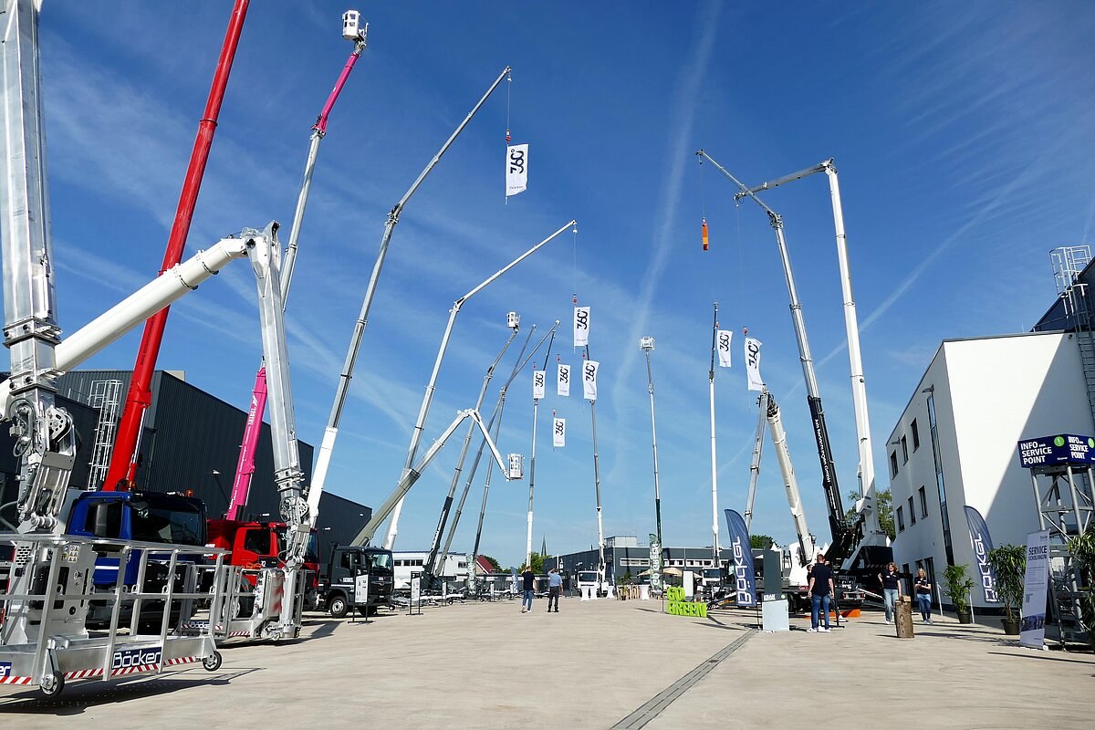 Böcker truck cranes and trailer cranes lined up with booms raised at the 360° Höhentage in Werne