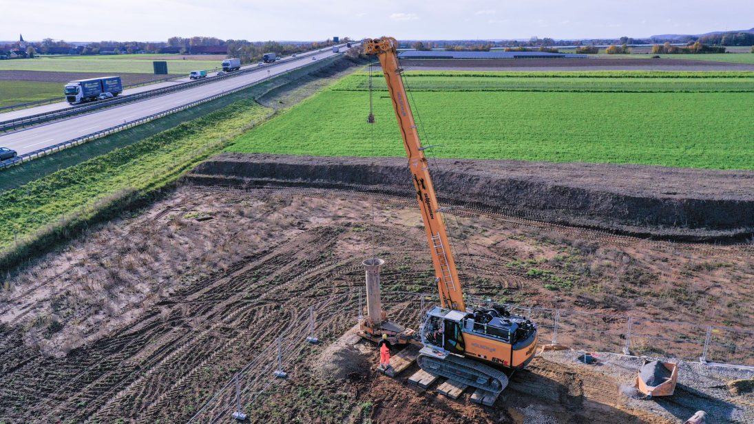 Duty cycle crane inserting a nine-metre well pipe into the drill pipe