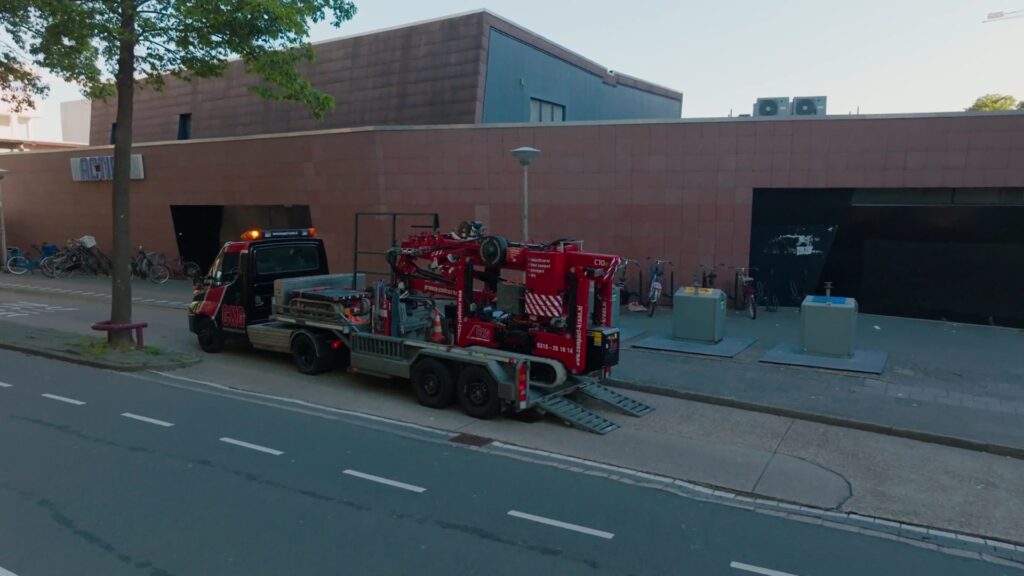 Hoeflon C10e loaded on a trailer outside the department store before set-up