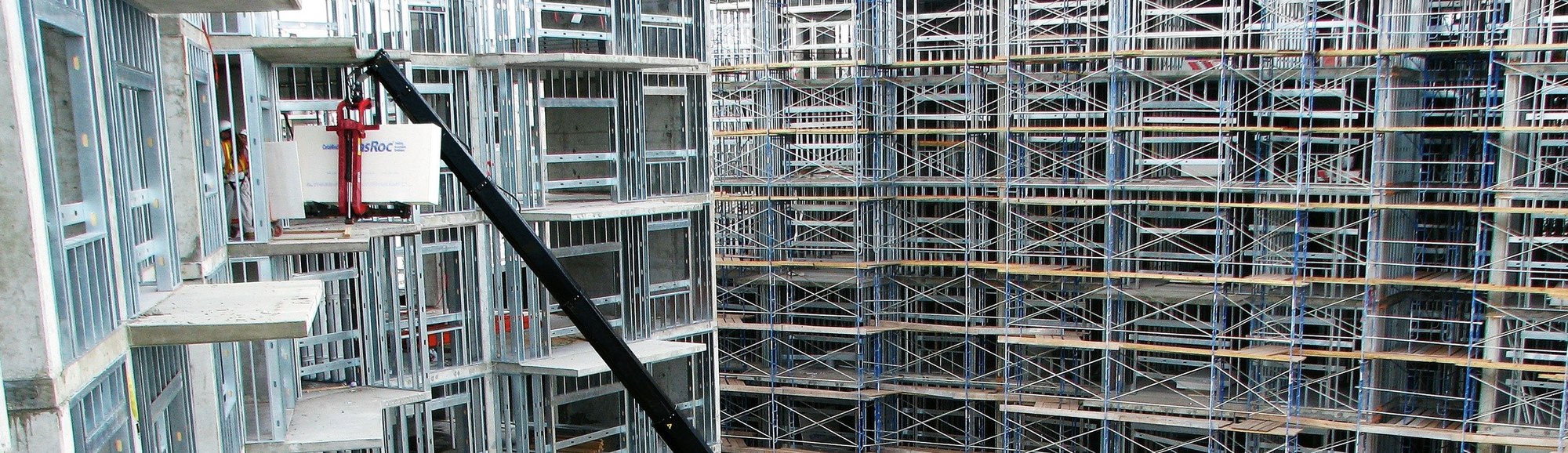 HIAB loader crane mounted behind the cab of an American truck on a construction site