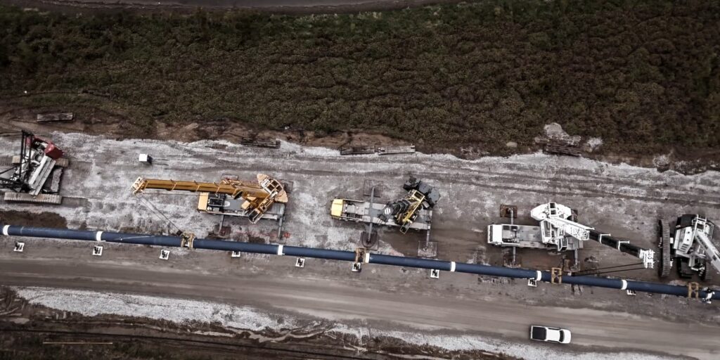 Aerial view of the Platte River pipeline crossing with cranes spaced along the pipe string