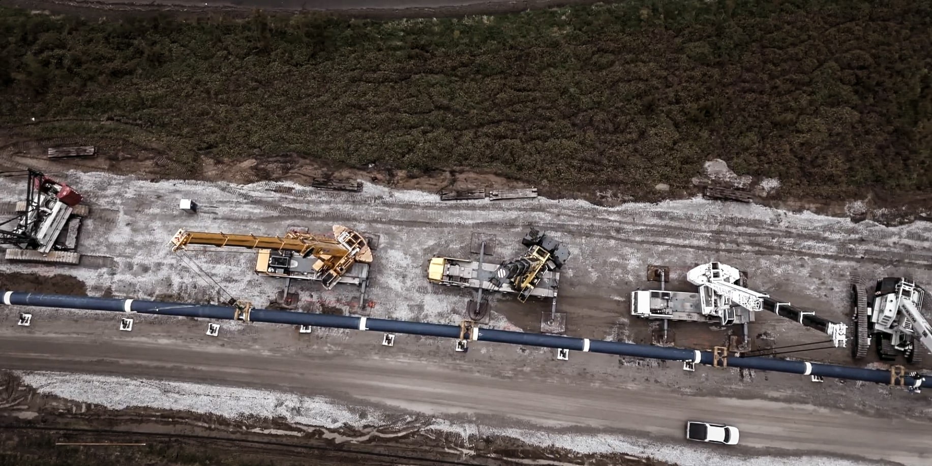 Aerial view of the Platte River pipeline crossing with cranes spaced along the pipe string