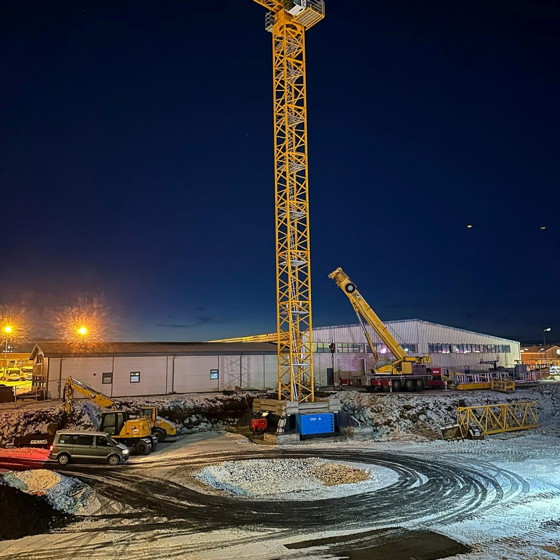 Potain MDT 489 tower crane being erected at night on the Hafnarfjörður jobsite in Iceland