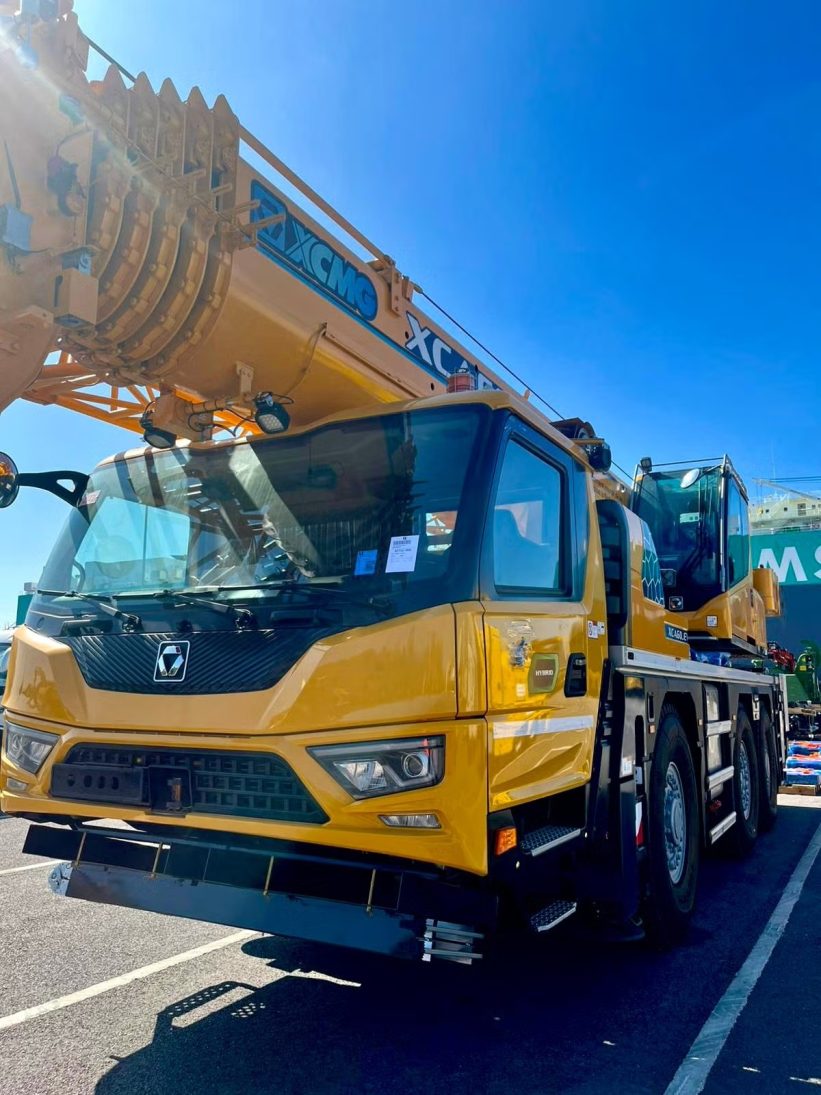 Front view of the three-axle XCMG XCA60_EV hybrid all-terrain crane at the UK port
