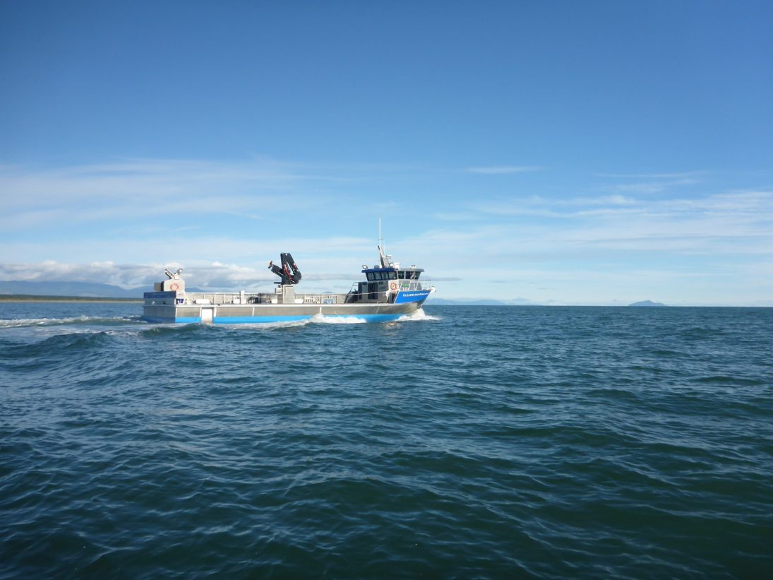 Workboat fitted with a Hiab marine loader crane running offshore
