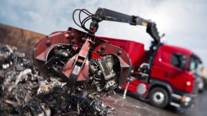HIAB eX.HIPRO loader crane fitted with a grab handling scrap at a recycling yard