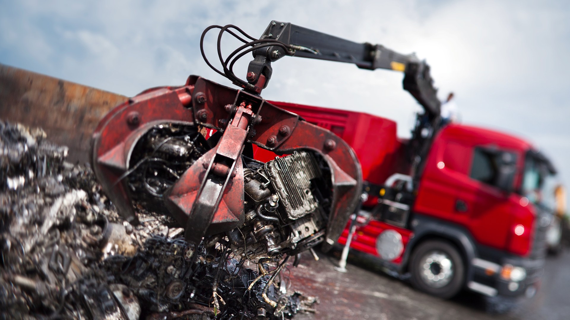 HIAB eX.HIPRO loader crane fitted with a grab handling scrap at a recycling yard