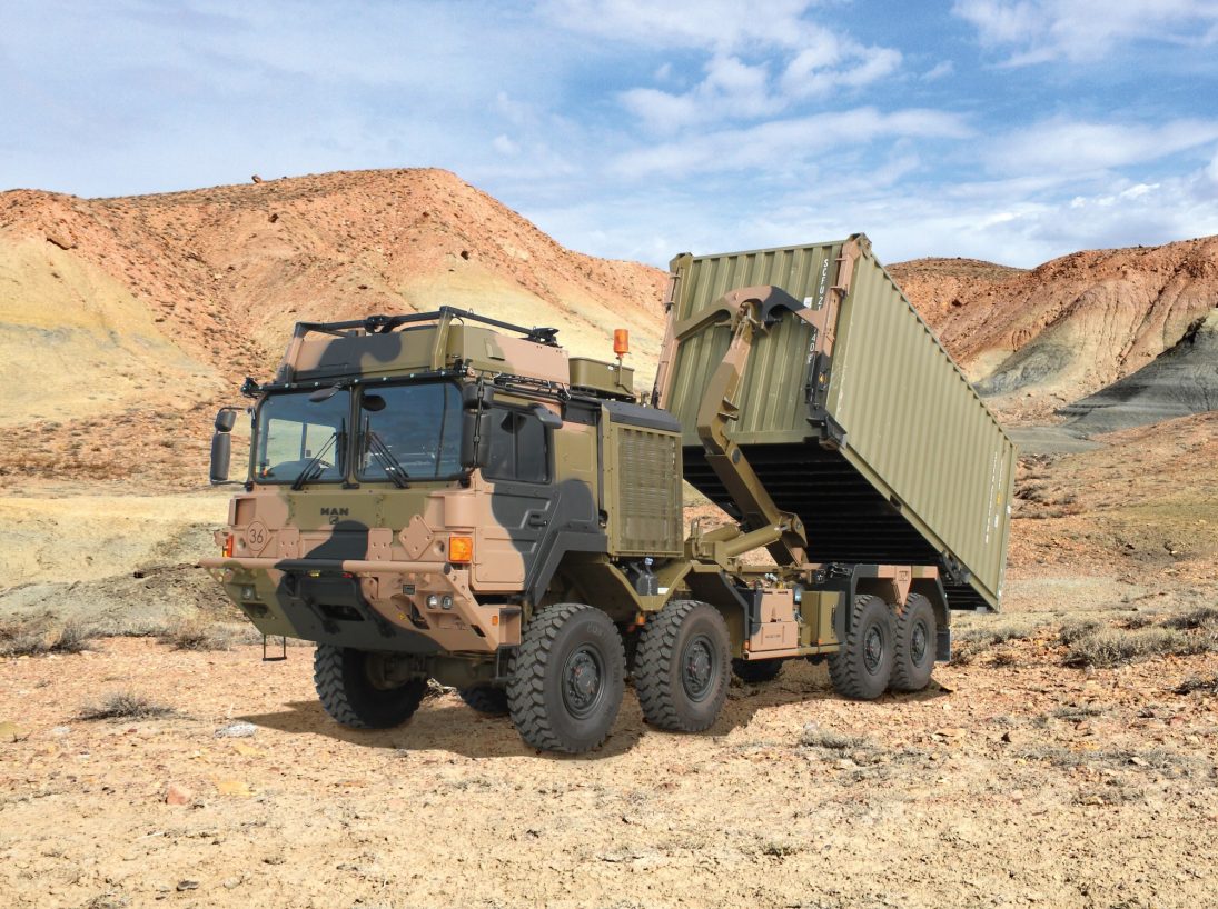 Hiab hooklift unloading an ISO container from an armoured MAN 8x8 military truck