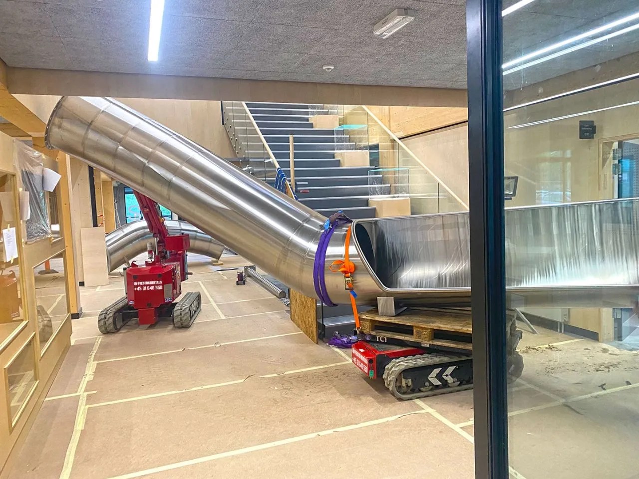 Hoeflon TC1 tracked carrier moving a slide section through a confined interior