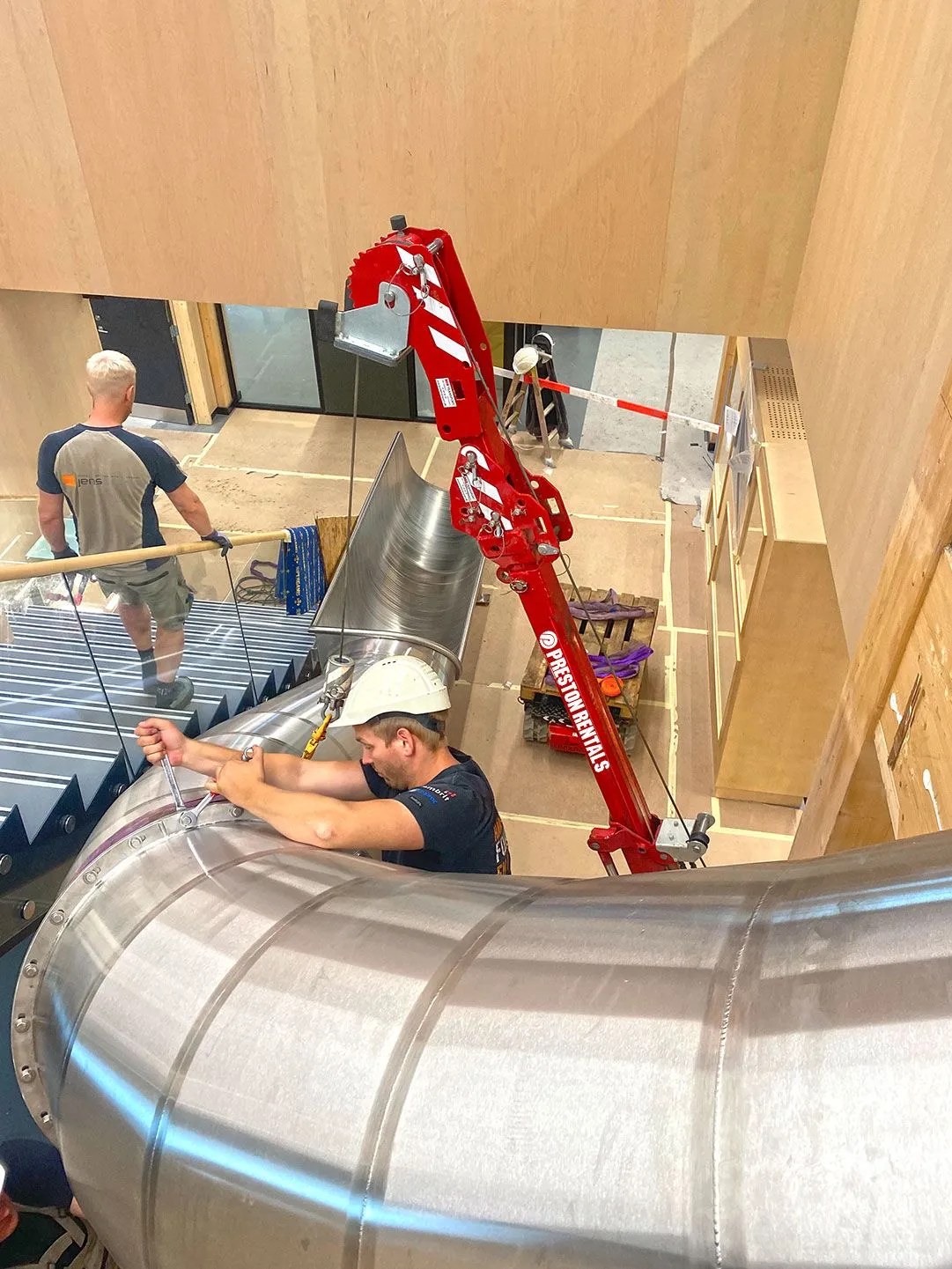 Hoeflon C1e lifting a slide element into position for Preston Rentals