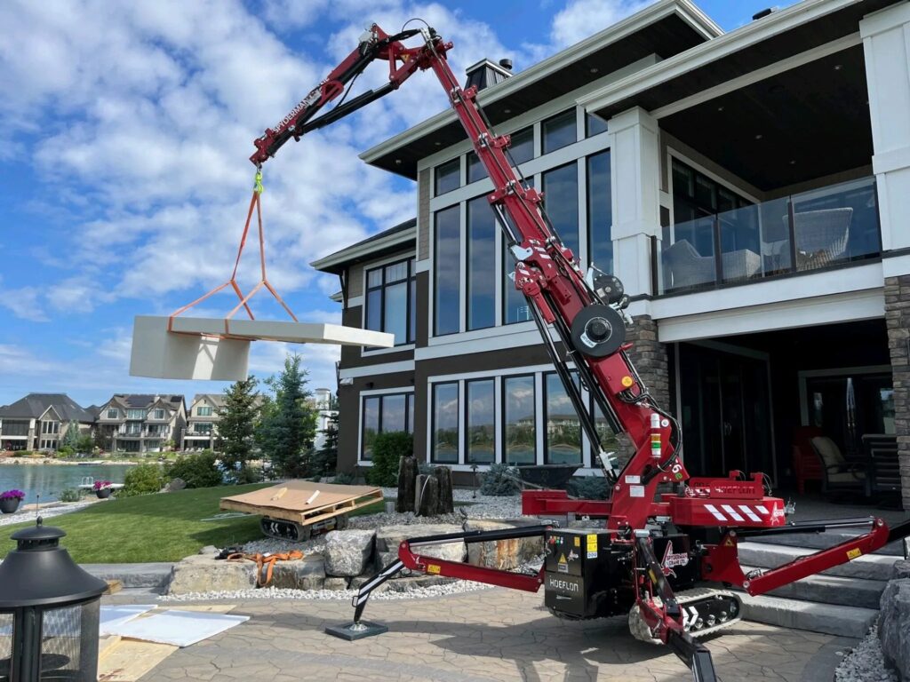 Hoeflon C6e compact crane set up on outriggers on a construction site