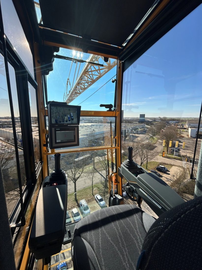 Renewed Spierings mobile tower crane cab mounted on the tower with the jib overhead