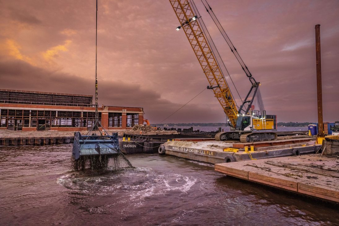 Liebherr HS 8100.1 duty cycle crawler crane dredging from a barge at Jacksonville, Florida