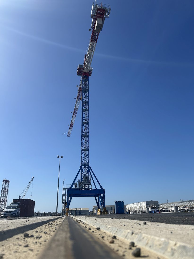 Potain tower crane mounted on a Lift Solutions rail-travelling gantry at a French shipyard