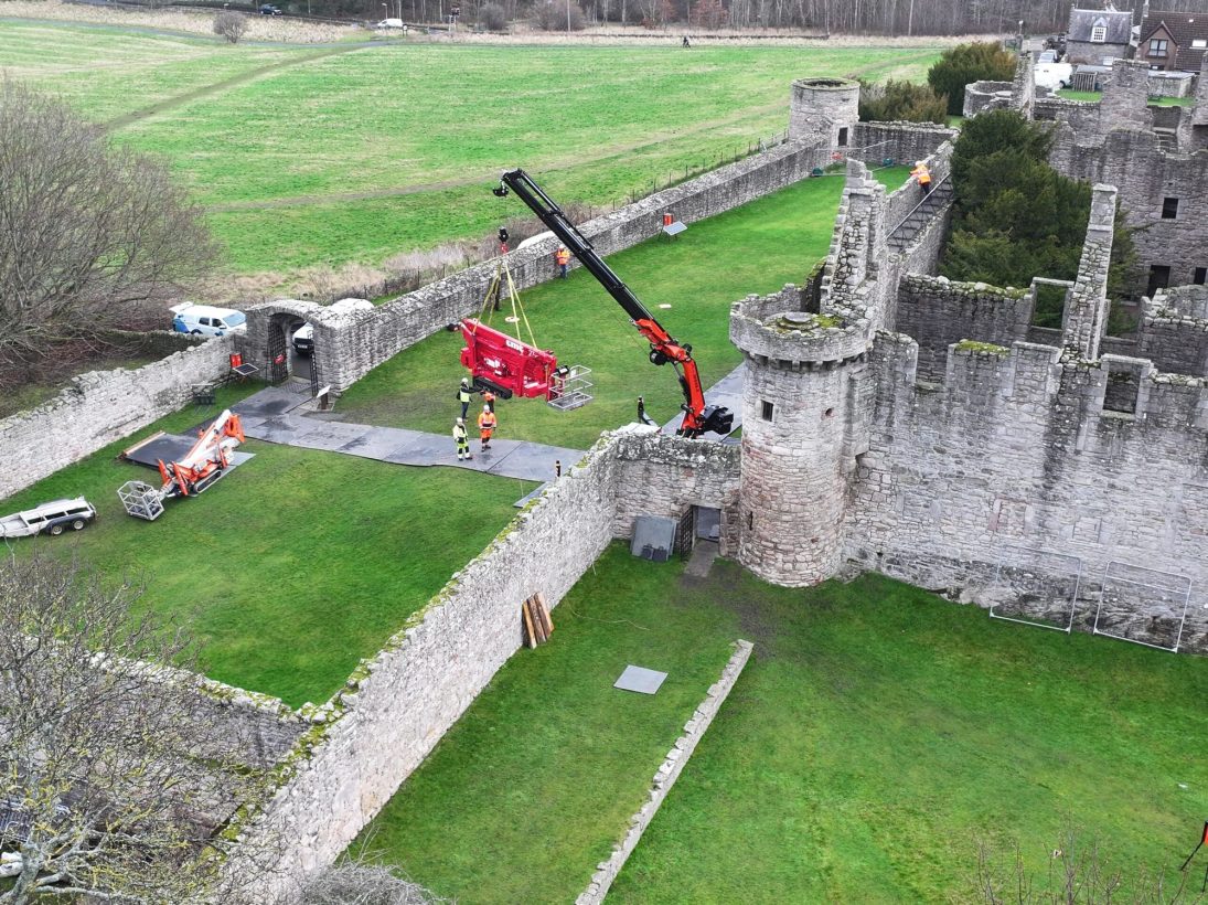 Jekko JF545.2 crawler crane passing the narrow medieval arch-gate at Craigmillar Castle