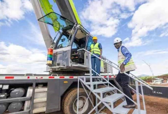 Kenyan President William Ruto operating a Zoomlion ZTC600V truck crane at the National Housing Project launch