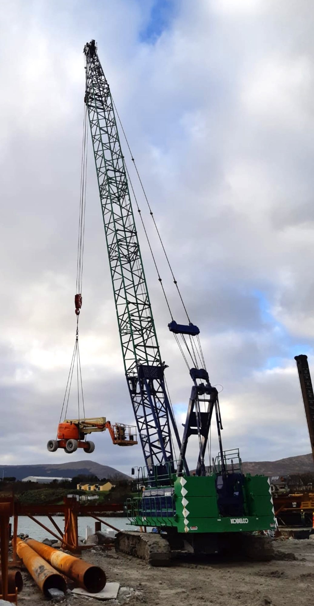 Kobelco BM700 crawler crane pitching sheet piles from a jack-up barge at Castletownbere