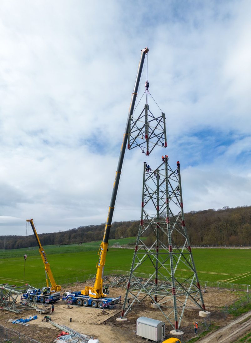 Lattice tower element being brought upright by Albert Regel's Liebherr mobile cranes