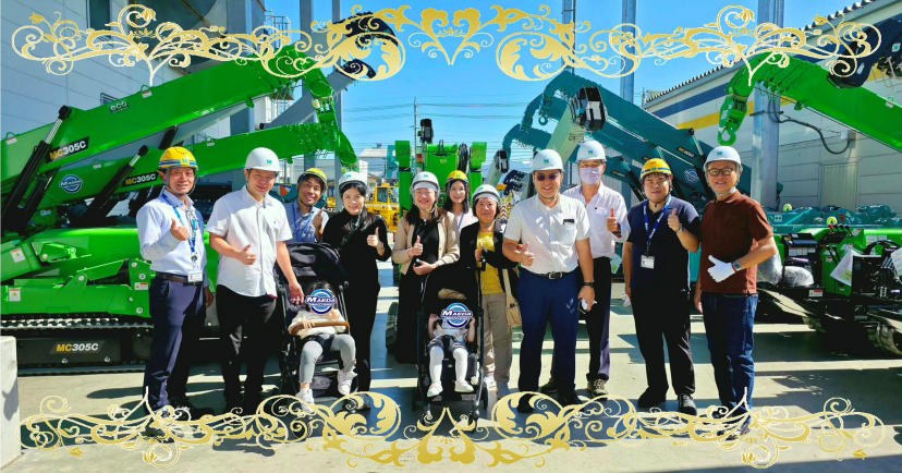 Visitors from Sin Loy Heng Engineering and TH Tong Heng Machinery in front of Maeda spider cranes in Nagano