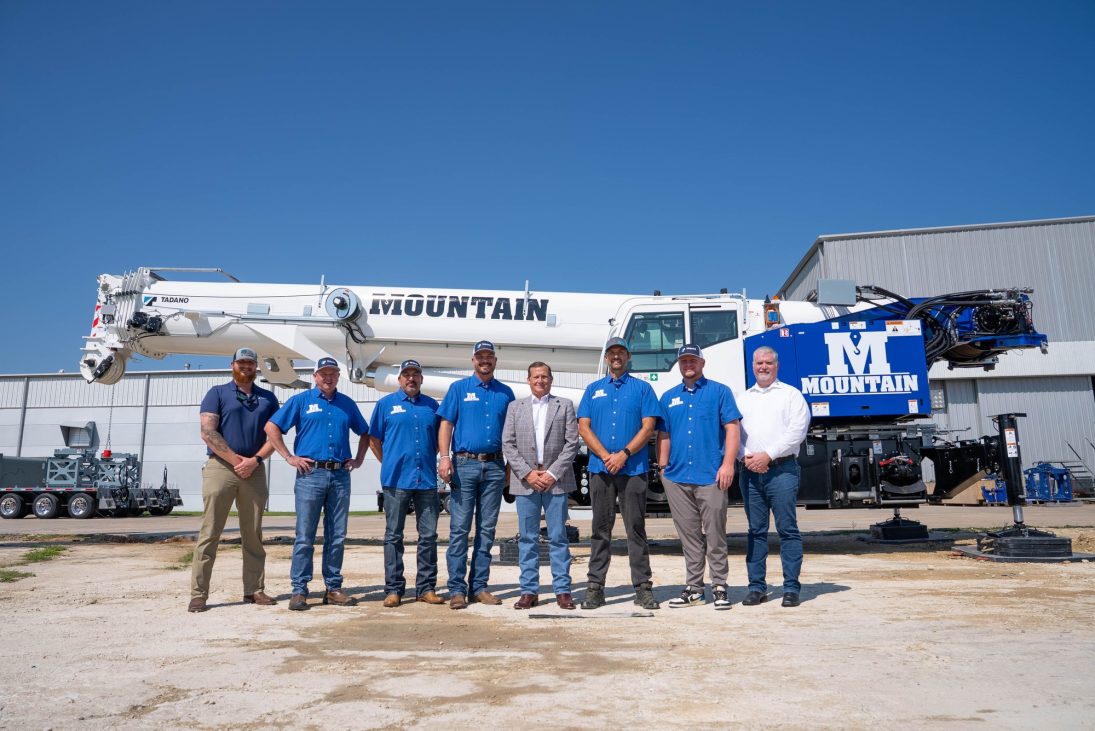 Mountain Crane and Tadano staff in front of a Tadano rough terrain crane in Mountain livery