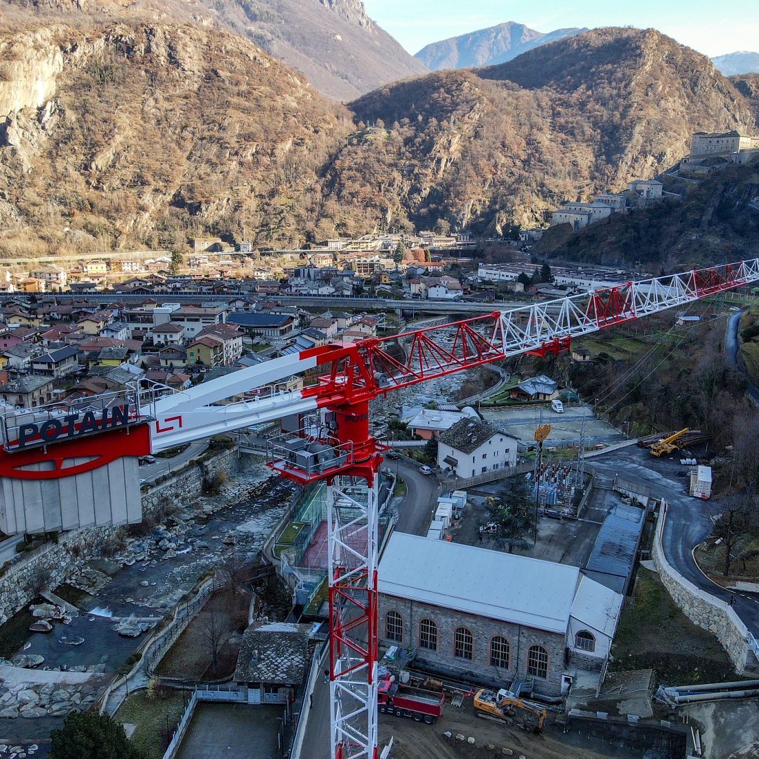 Potain MDT 269 J12 topless tower crane with its 65 m jib over the Hone hydroelectric plant in the Aosta Valley