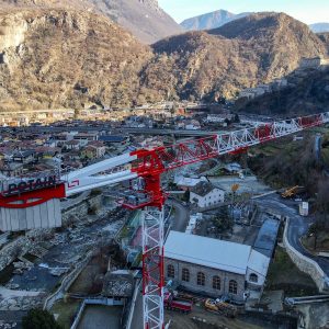 Potain MDT 269 J12 topless tower crane with its 65 m jib over the Hone hydroelectric plant in the Aosta Valley