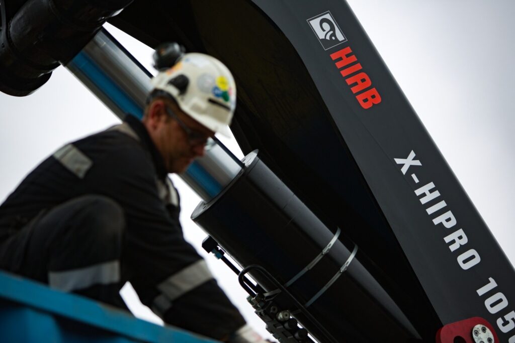 Technician working on the boom of a HIAB X-HiPro 1058 loader crane