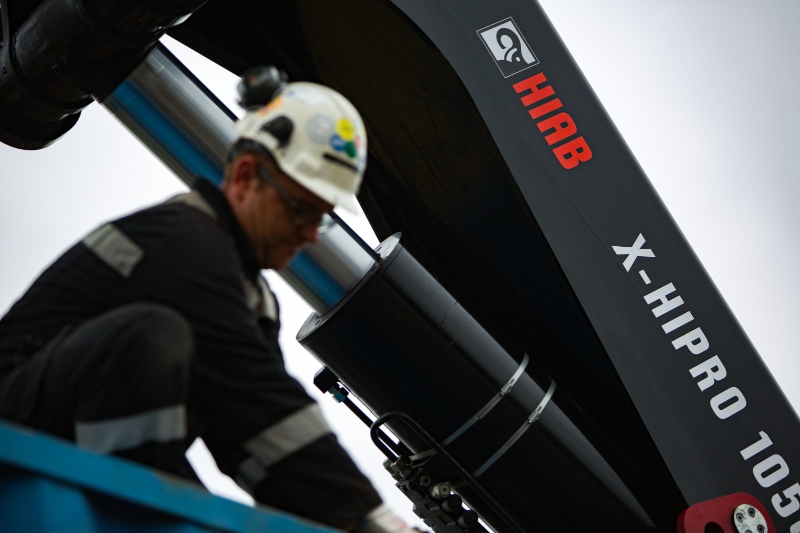 Technician working on the boom of a HIAB X-HiPro 1058 loader crane