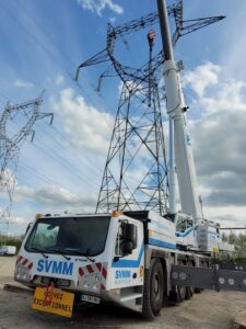 S.V.M.M.'s new Tadano AC 5.250L-2 all terrain crane rigged beside electricity pylons in northern France