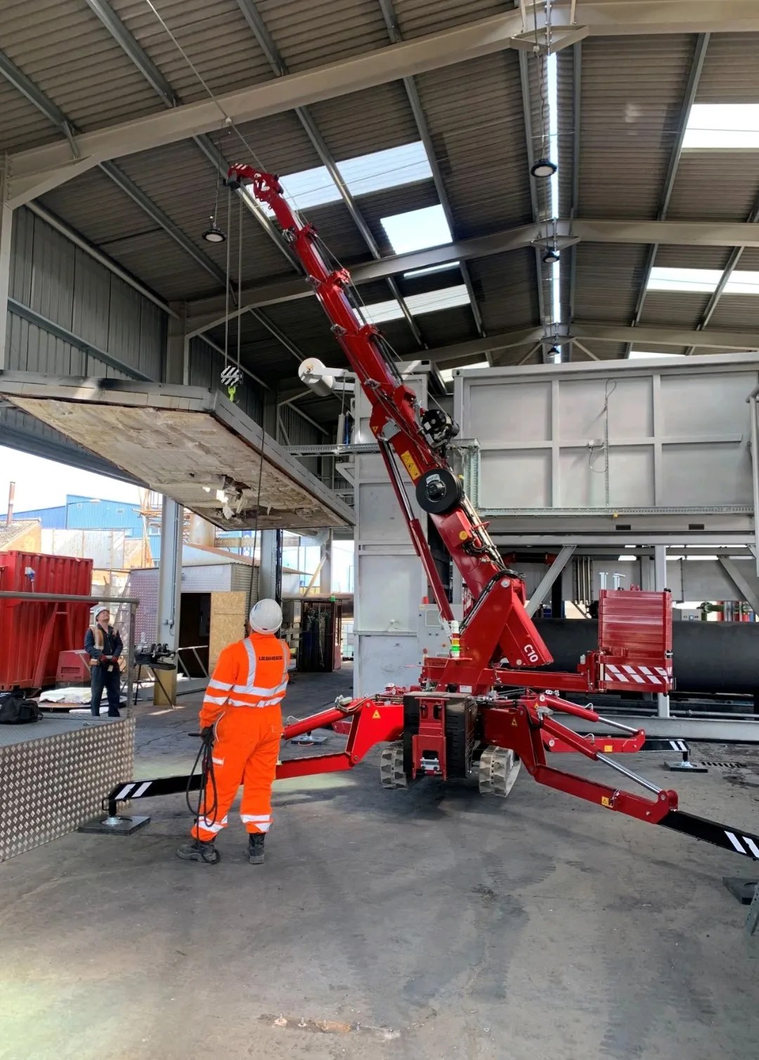 Hoeflon C10 mini crane lifting a load inside a confined building