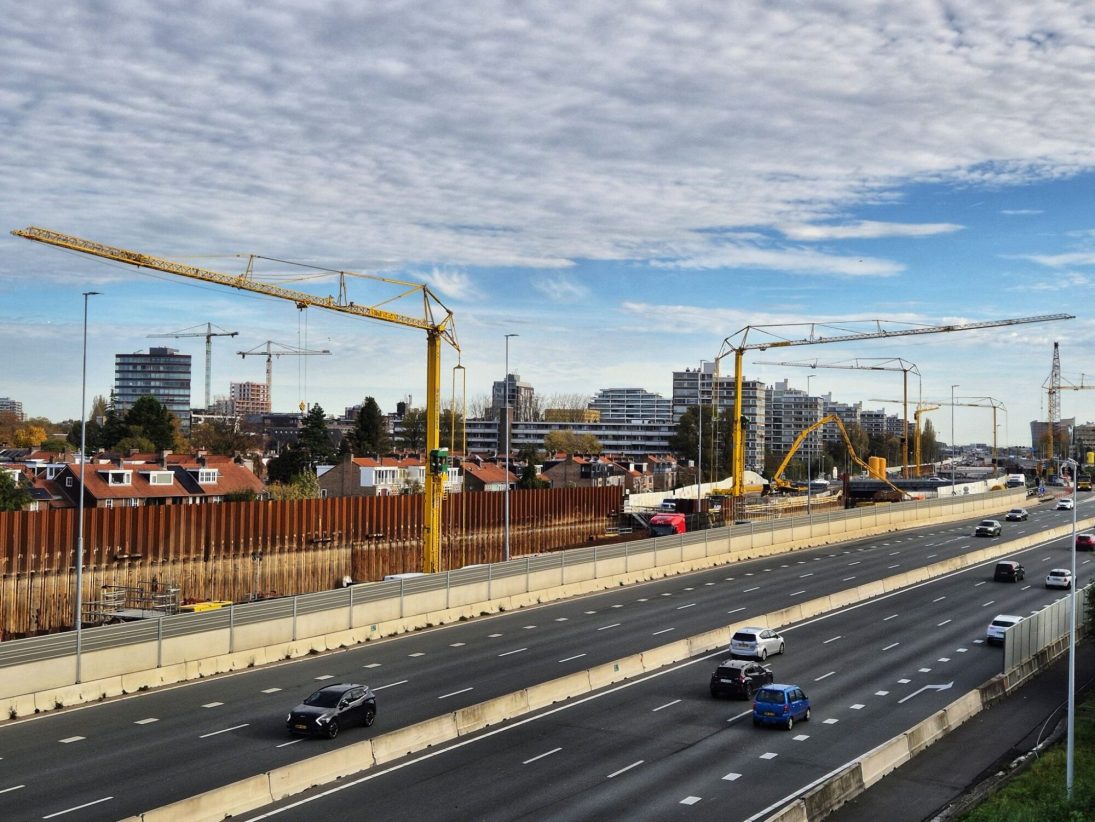 Spierings mobile tower cranes standing beside the A9 motorway widening works with traffic running past