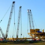Link-Belt 348 Series 2 crawler cranes lifting modular steel components at the State Service yard in Ingleside, Texas