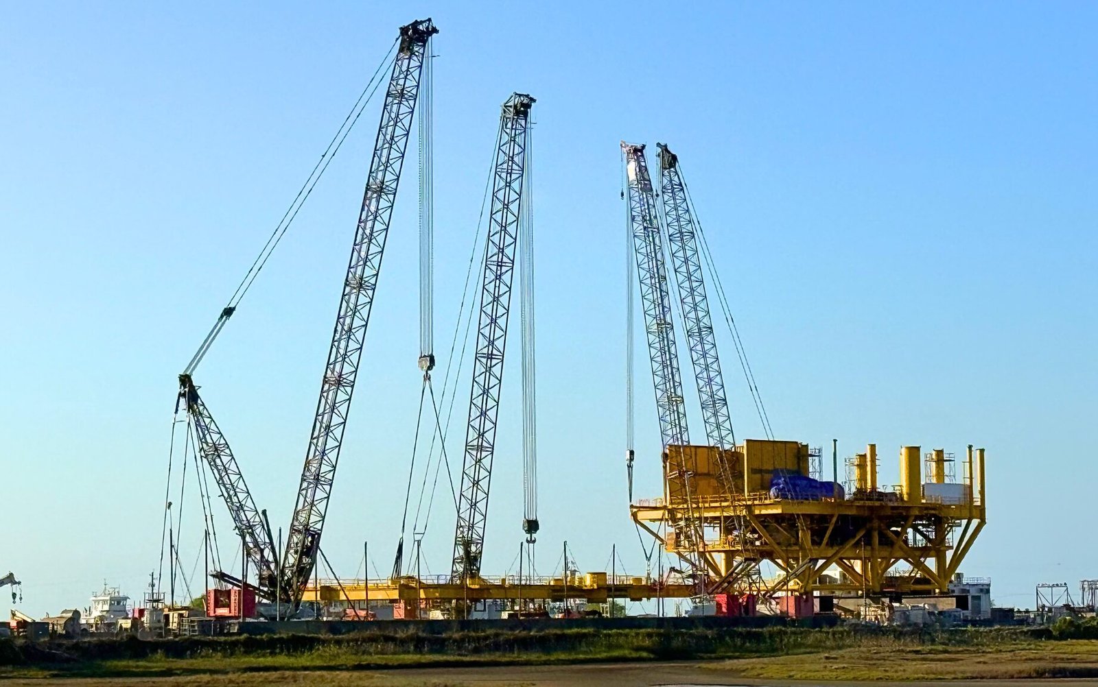 Link-Belt 348 Series 2 crawler cranes lifting modular steel components at the State Service yard in Ingleside, Texas