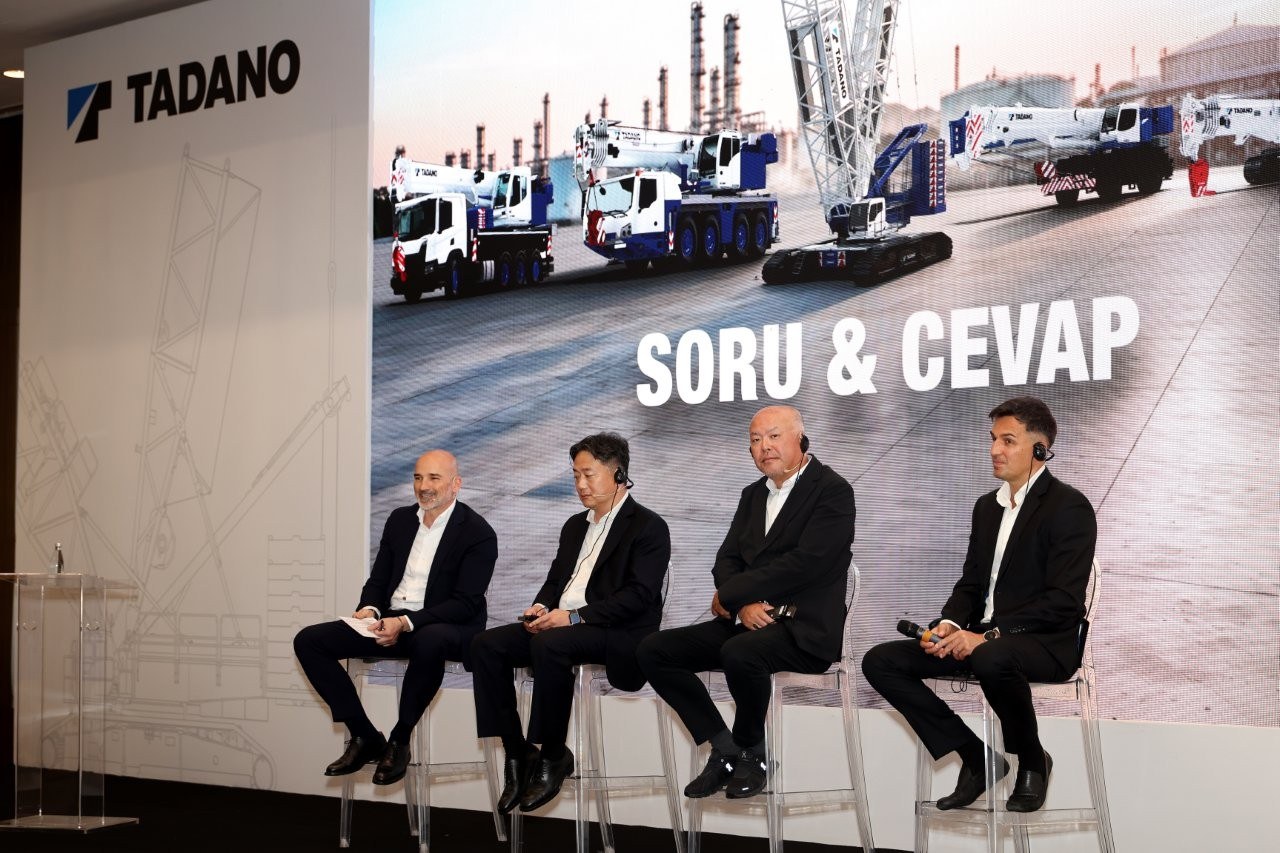 Panel session at the Tadano and Marubeni Distribution and Service announcement, with Tadano all terrain and crawler cranes on the backdrop