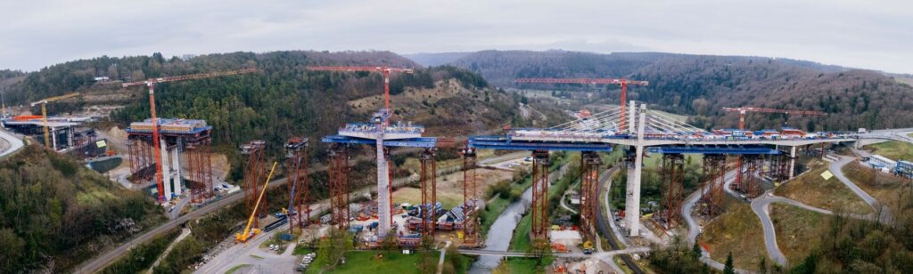 Aerial panorama of the Neckartal bridge construction site near Horb with tower cranes and mobile cranes at work
