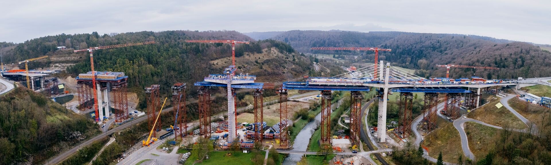 Aerial panorama of the Neckartal bridge construction site near Horb with tower cranes and mobile cranes at work