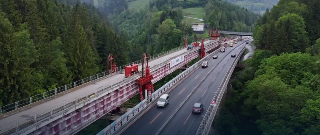 Strand jack portals on the Steinbruckenbach viaduct deck above live traffic on the A10 motorway in Austria