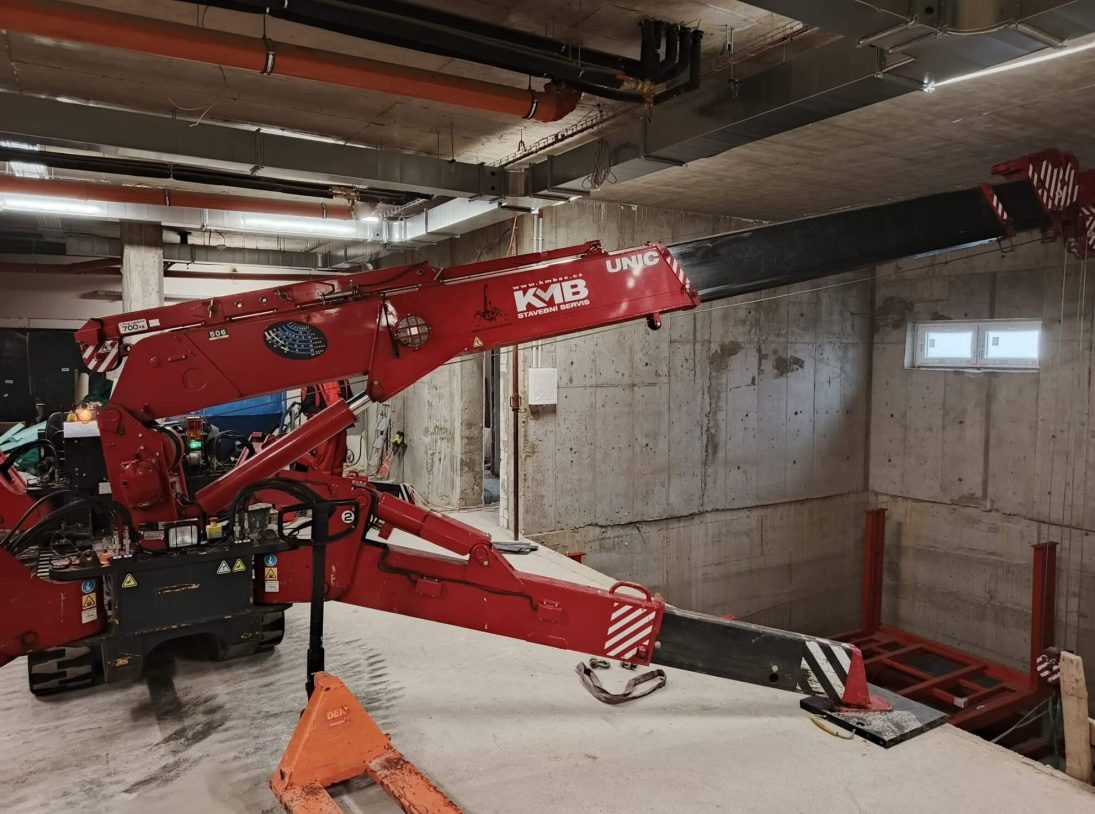 UNIC URW-506 rigged on outriggers beneath the low ceiling of a Prague underground garage