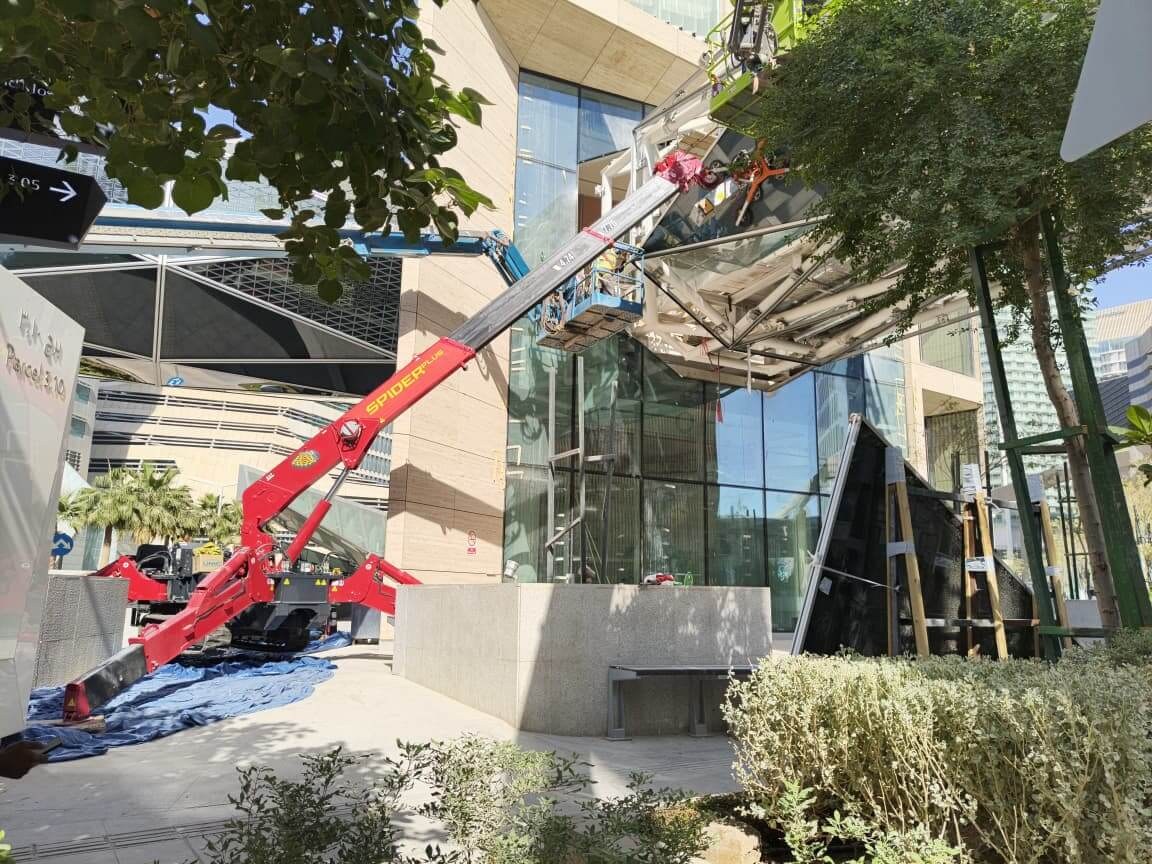 UNIC URW-547 spider crane with glass manipulator installing a triangular glass panel at King Abdullah Financial District, Riyadh
