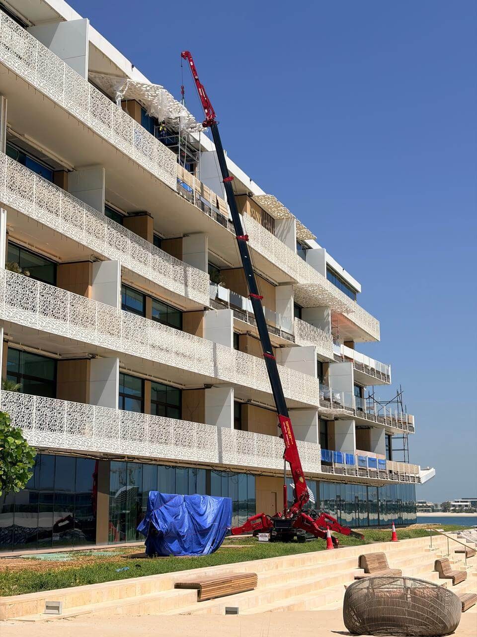 UNIC URW-706-2 spider crane positioned for GRC panel installation at the BVLGARI Resort, Jumeirah Bay