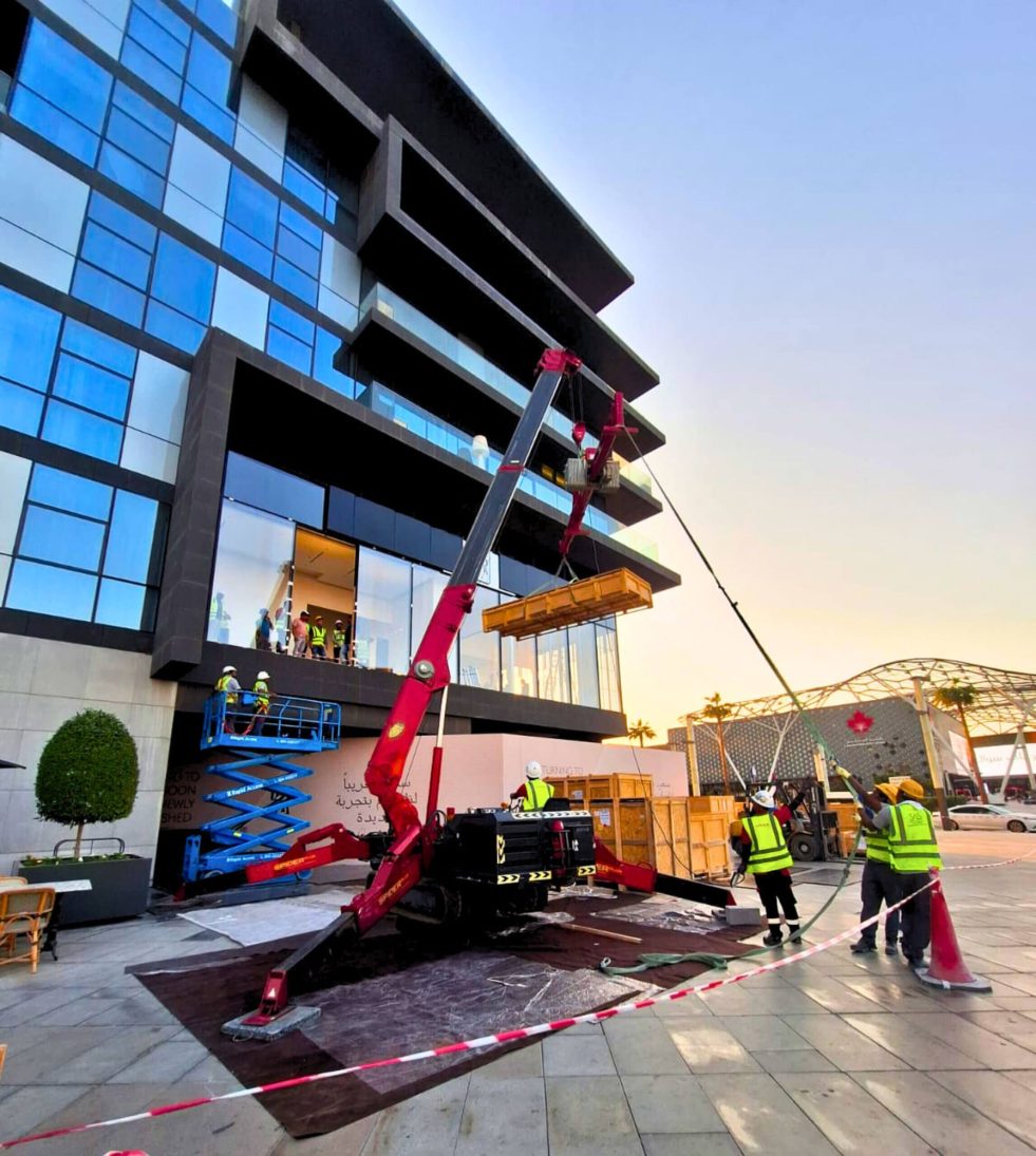 UNIC URW-706 spider crane rigged for a second-floor lift during the Dubai showroom renovation