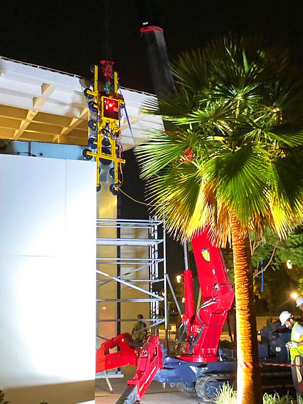 UNIC URW-706 lifting a large glass panel at the Zayed University main entrance