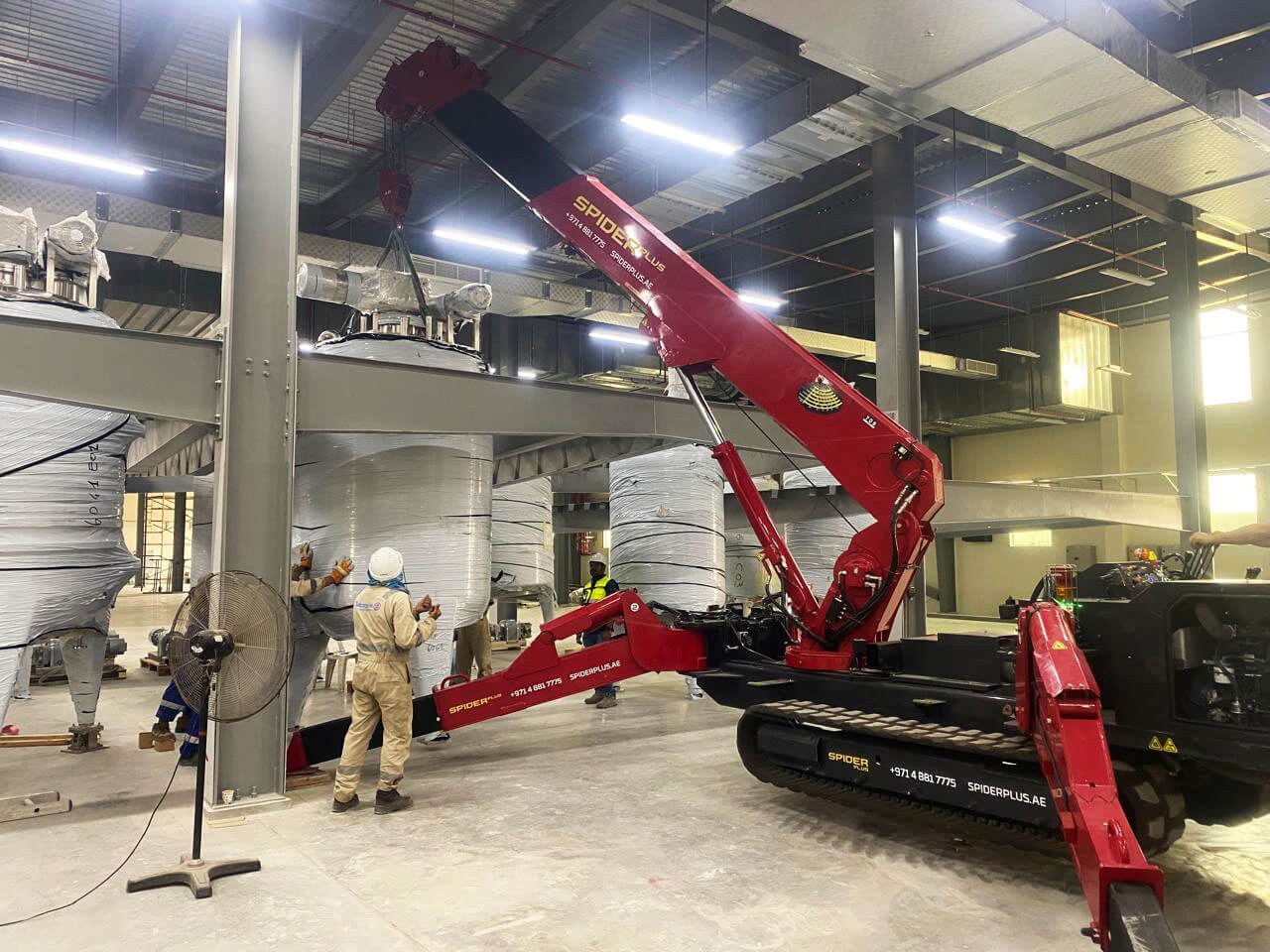 UNIC URW-706 spider crane positioning a storage tank at the Falcon Pack facility in Ras Al Khaimah