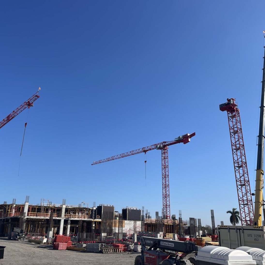 Two Potain MDT389-L16 tower cranes and a Potain MD559 on the Miami administration building site