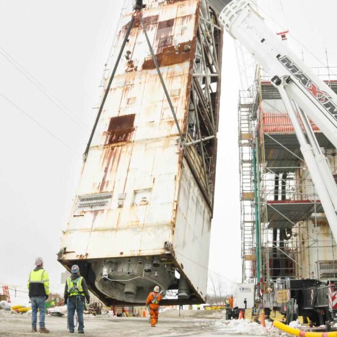 Cold box module tailed down by an all-terrain crane during the dismantle