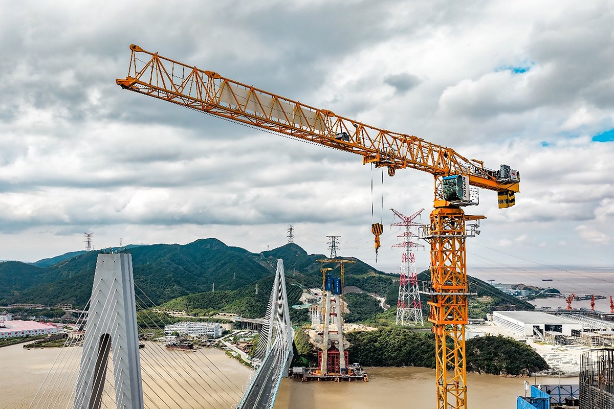 Flat-top tower crane working on a bridge construction project